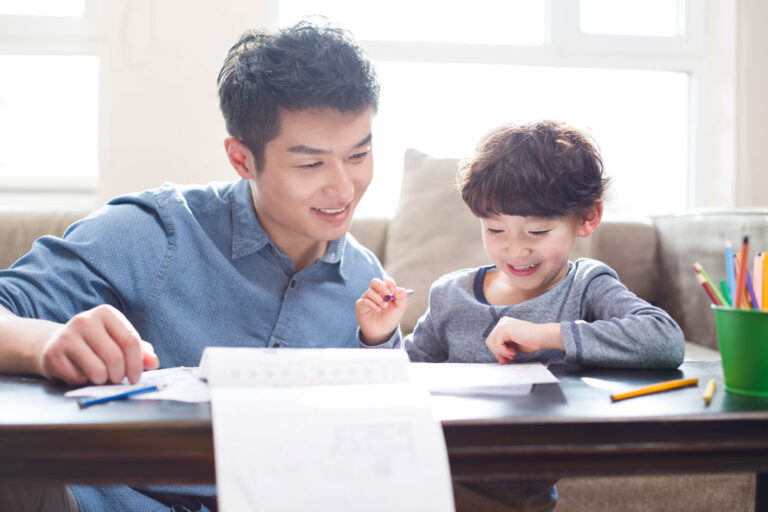young-father-helping-son-with-homework-2024-10-16-11-59-41-utc